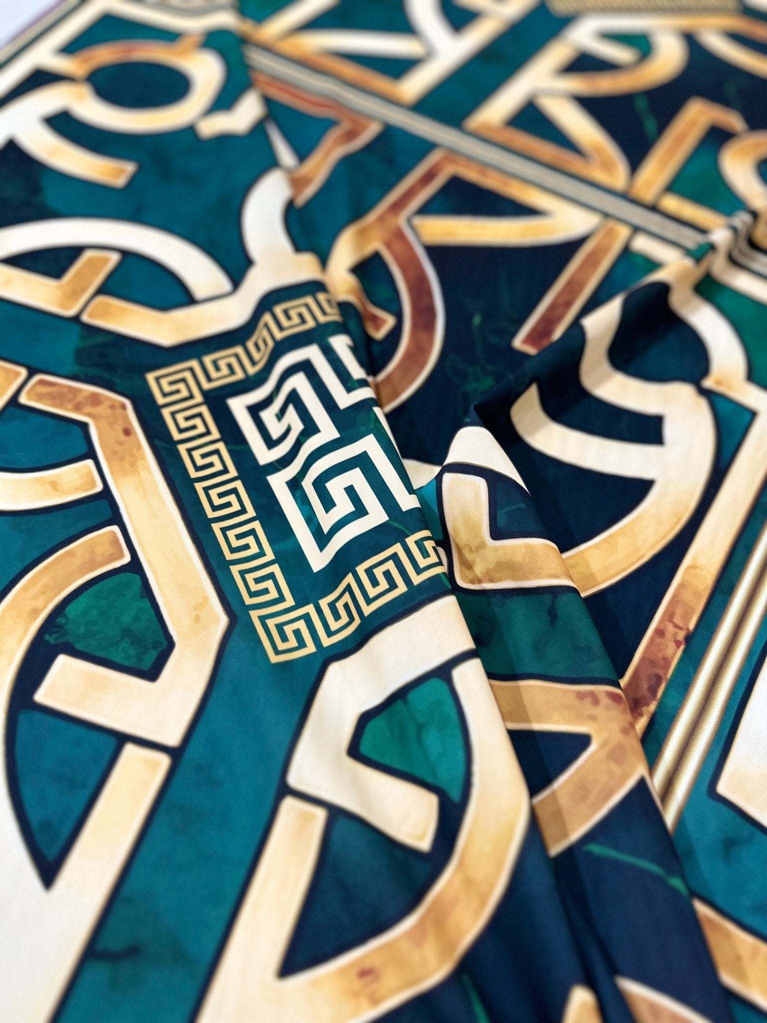 Green Gold crepe silky fabric with Greek Key pattern and smooth texture