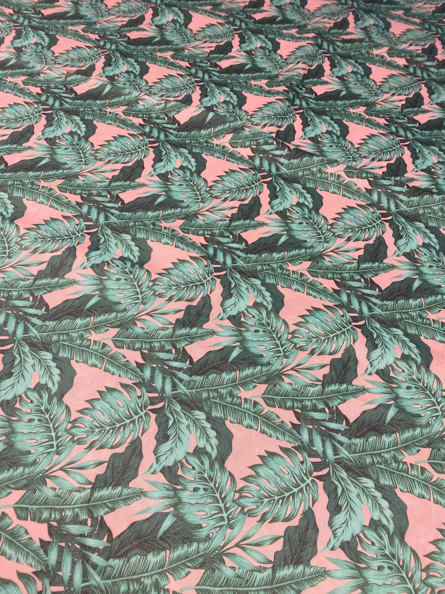 green leaf pattern linen fabric with vibrant tropical leaves on pink background for home decor