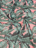 Green leaf pattern linen fabric with teal leaves on pink background for stylish home decor
