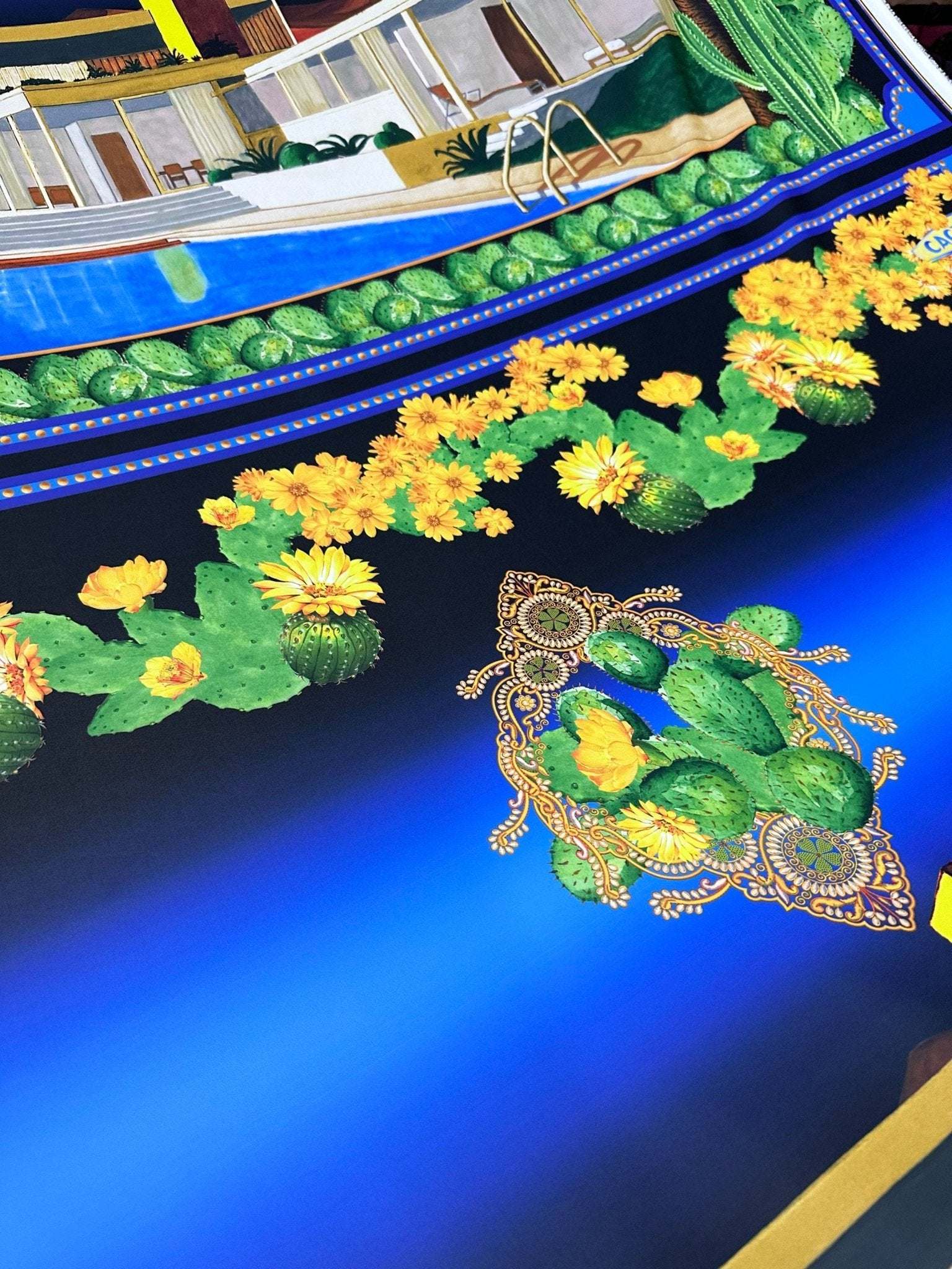 Close-up of Palm Springs Retro Hotel Print Fabric featuring vibrant cactus and yellow flower design on a deep blue background