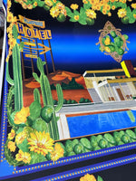 Palm Springs Retro Hotel Print Fabric with vintage desert motel and cactus design on vibrant blue background