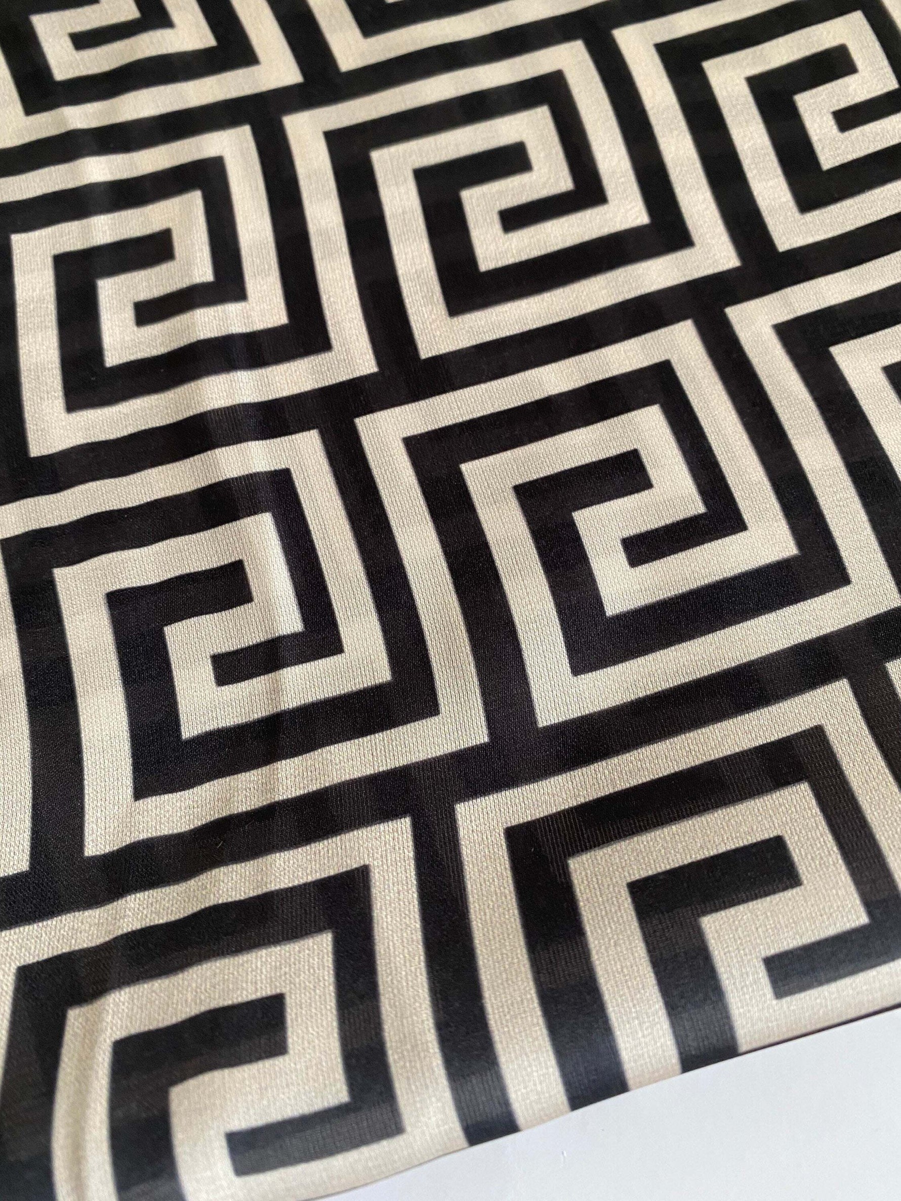 Close-up of black and white Greek Key Design Fabric with geometric pattern on 150cm wide textile material