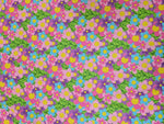vibrant colorful floral fabric with pink, purple, blue flowers and green leaves pattern