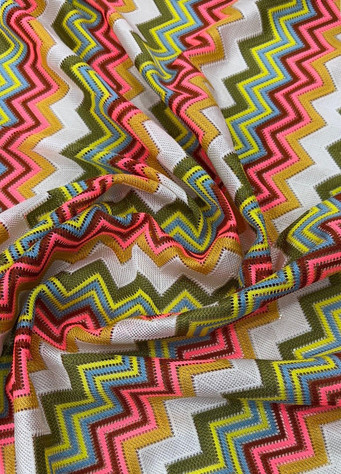 Multicolor zigzag knit jersey mesh fabric with vibrant zigzag pattern and breathable texture for crafting and apparel projects