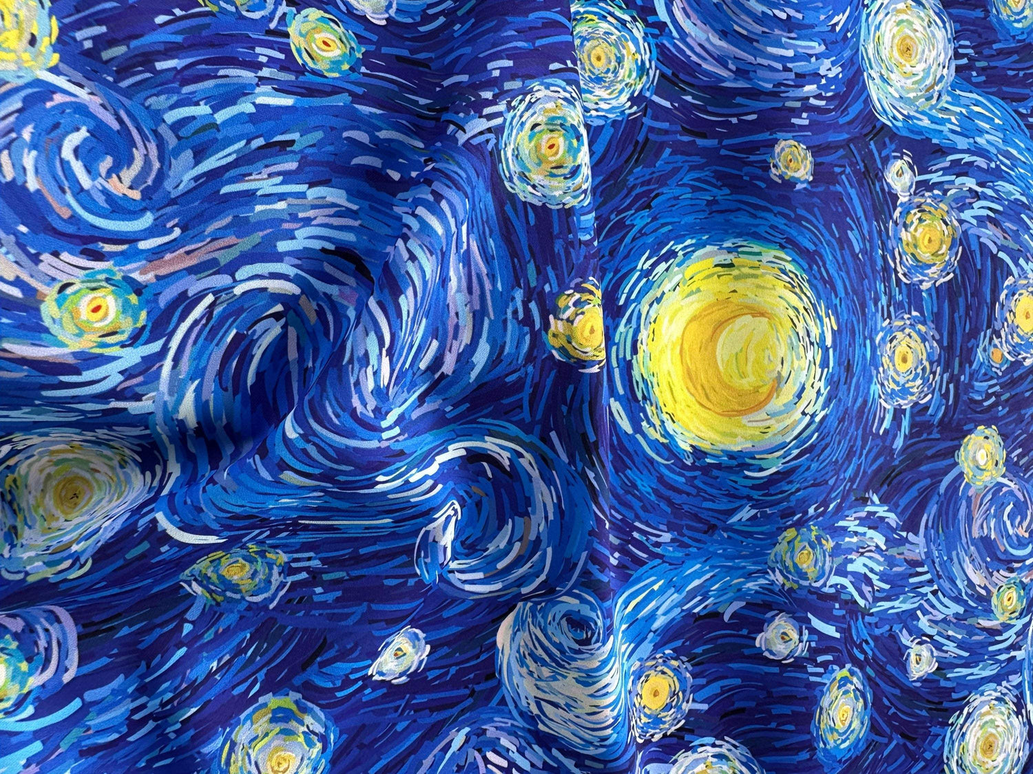 Van Gogh Inspired Fabric featuring vibrant Starry Night design in blue and yellow tones for sewing and quilting projects