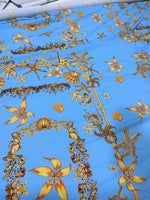 Blue fabric with detailed golden sea shell and starfish pattern for coastal-themed projects