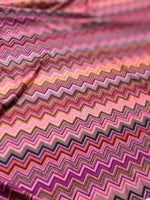 Close-up of colorful zigzag mesh stretch fabric with 4-way elasticity and vibrant pattern