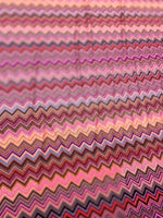 Close-up of colorful zigzag mesh stretch fabric with 4-way stretch and 150cm width