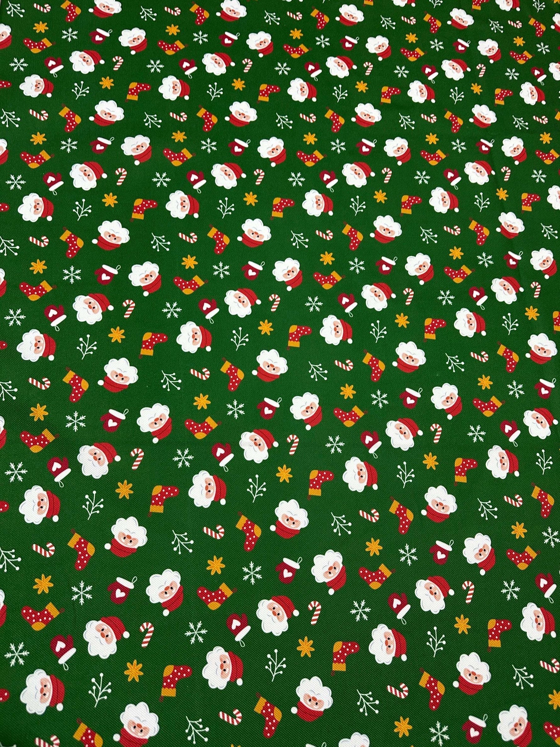 Green Santa Claus Christmas fabric with festive Santa and holiday icons on a green background