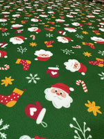 Green Santa Claus fabric with festive Christmas motifs on green background