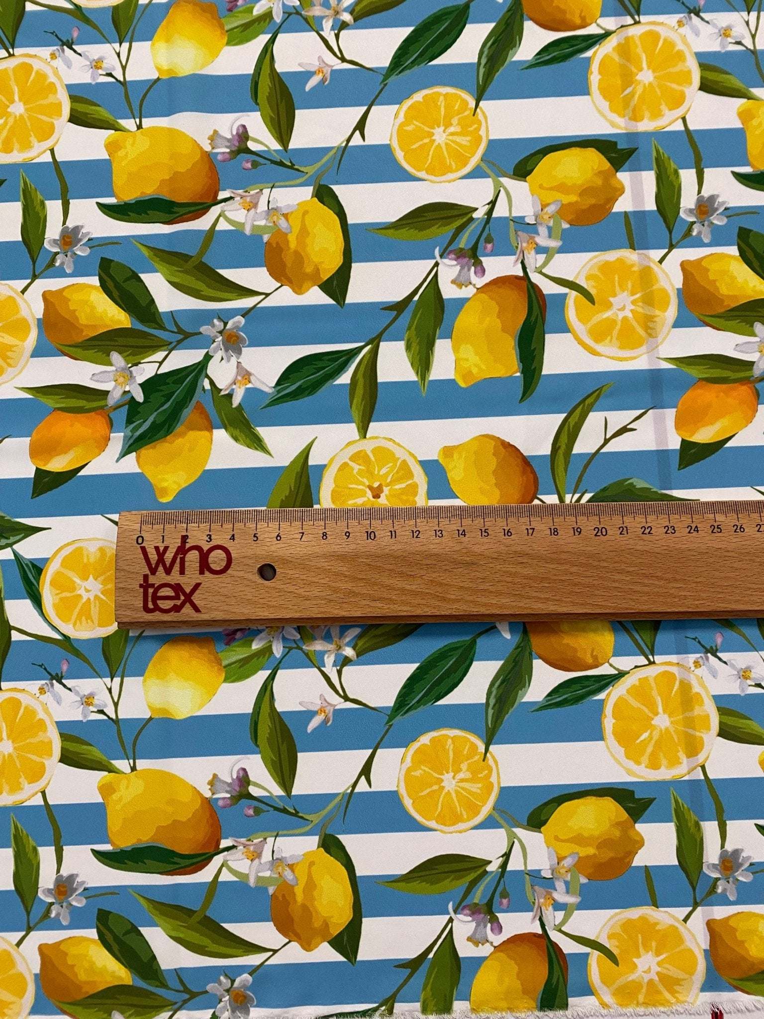 Lemon and floral print fabric with blue and white stripes and green leaves