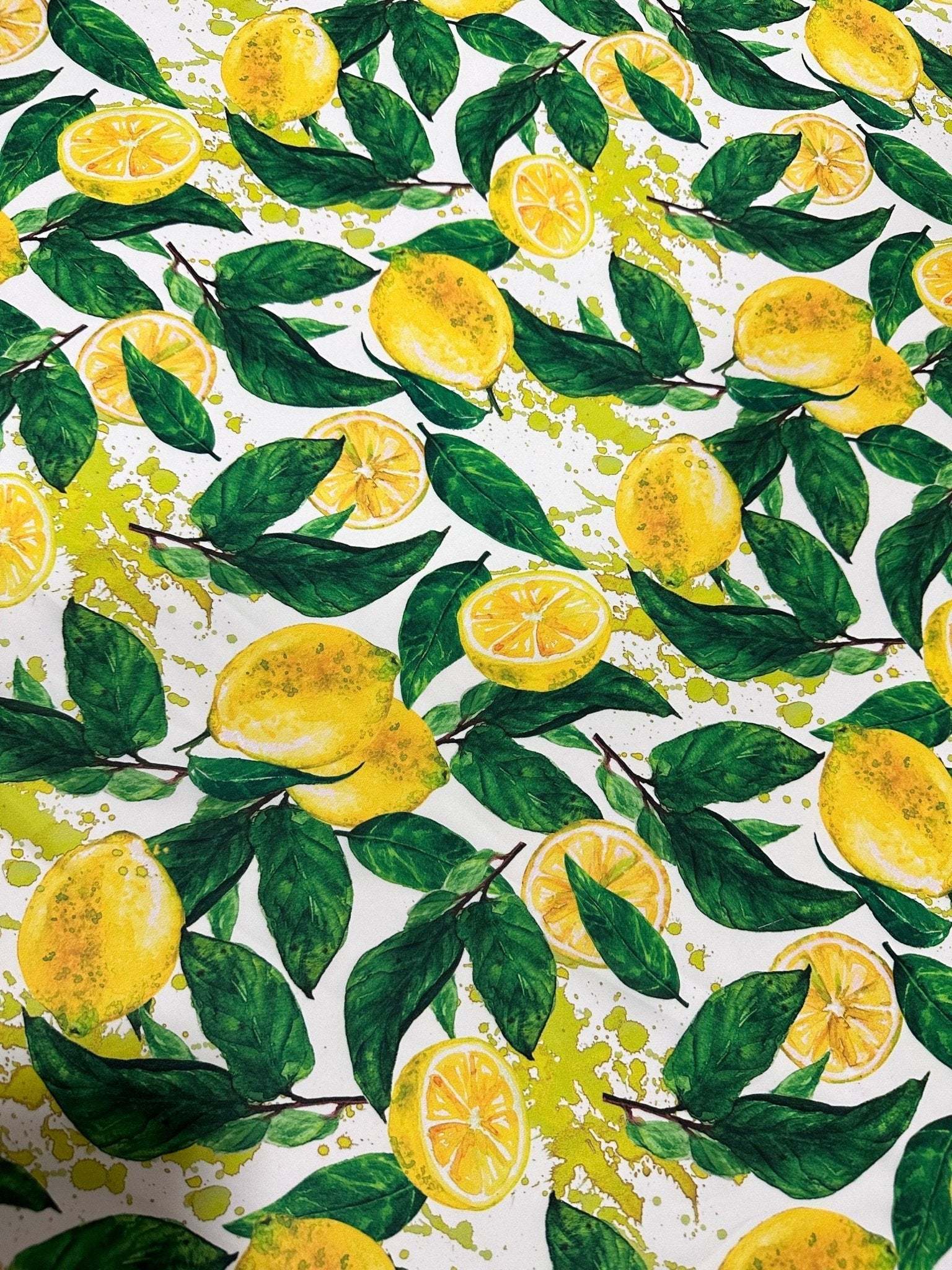 White cotton fabric with vibrant lemon pattern and green leaves design