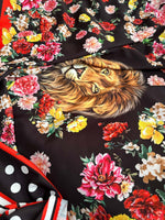 black floral print fabric with vibrant red, pink, yellow flowers and a detailed lion face design