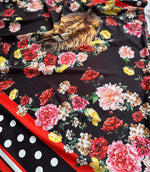 Black floral print fabric with vibrant red, pink, yellow flowers and lion face design