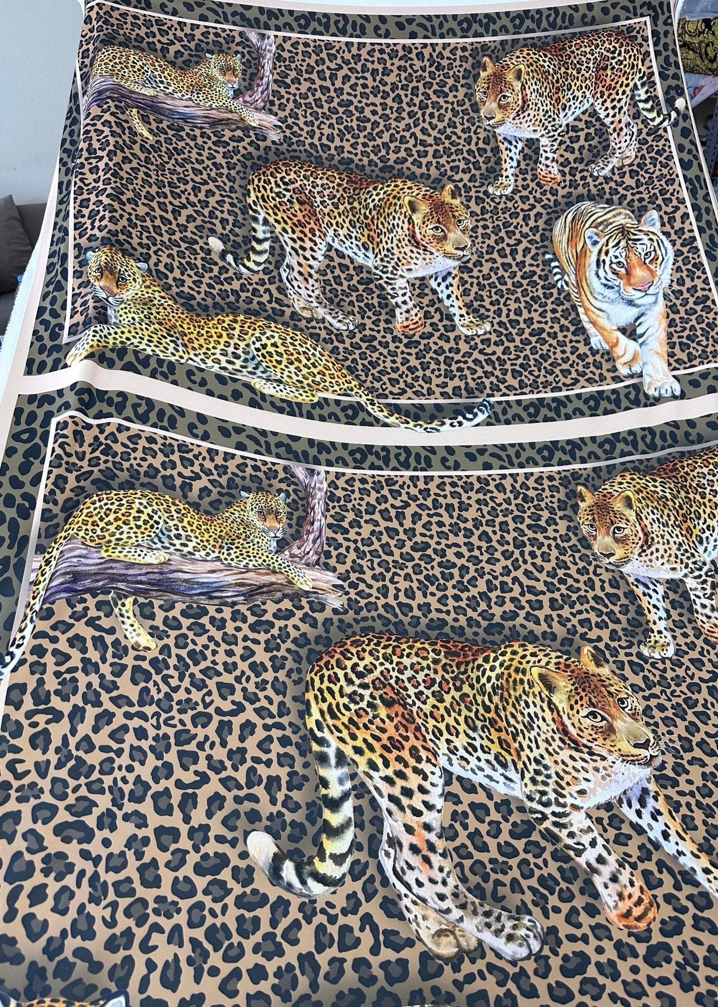 Leopard print crepe fabric featuring detailed leopard and tiger illustrations on a spotted background