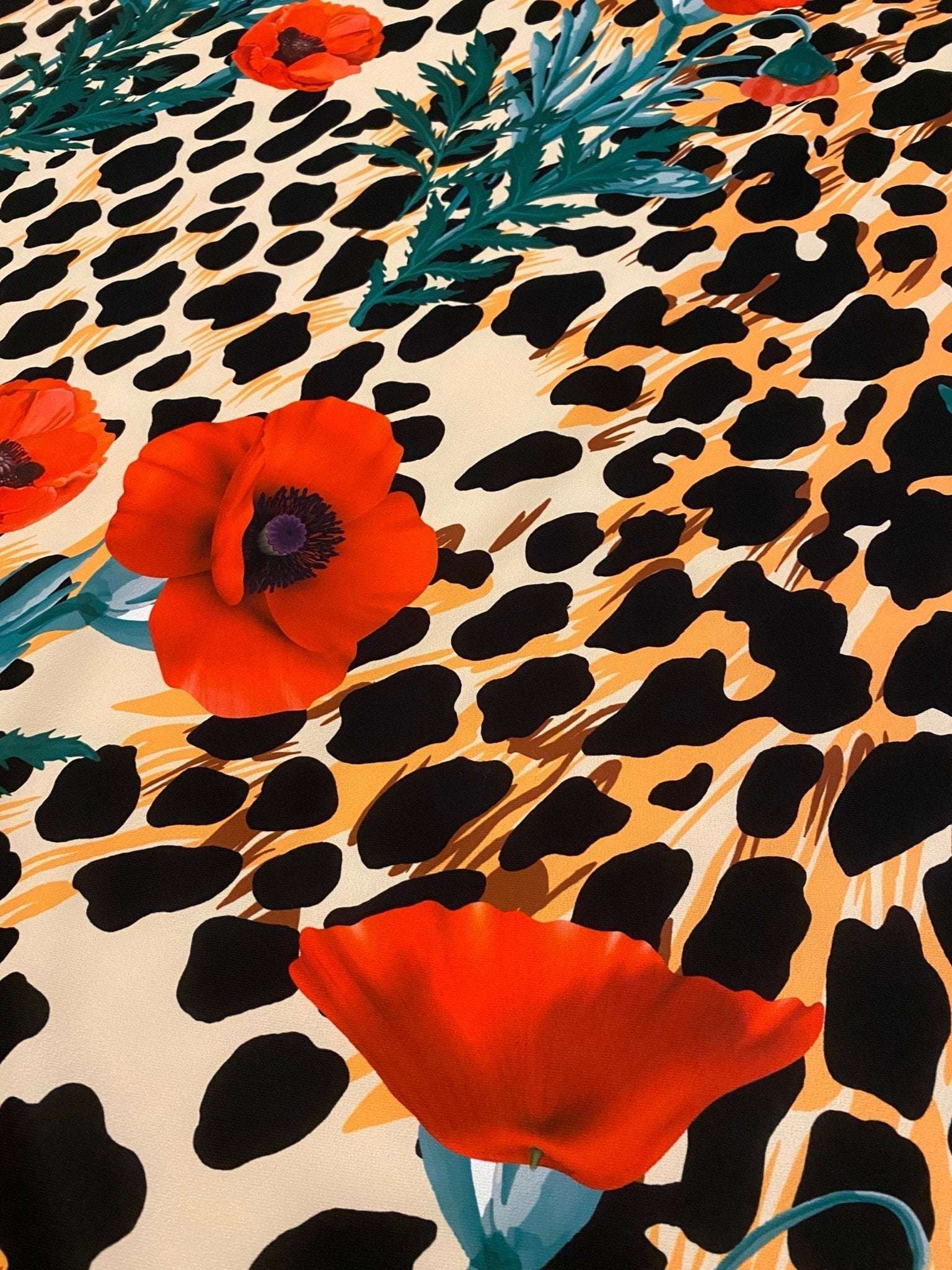 leopard poppy flower silky crepe fabric with vibrant red poppies and leopard print pattern