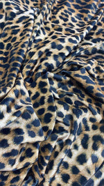Leopard pattern stretch velvet fabric with soft, lightweight, wrinkle-free texture suitable for clothing and home decor.