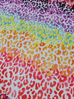 Multicolor leopard print fabric with vibrant red, orange, yellow, green, blue, and purple spots on a white background, fabric width 150cm