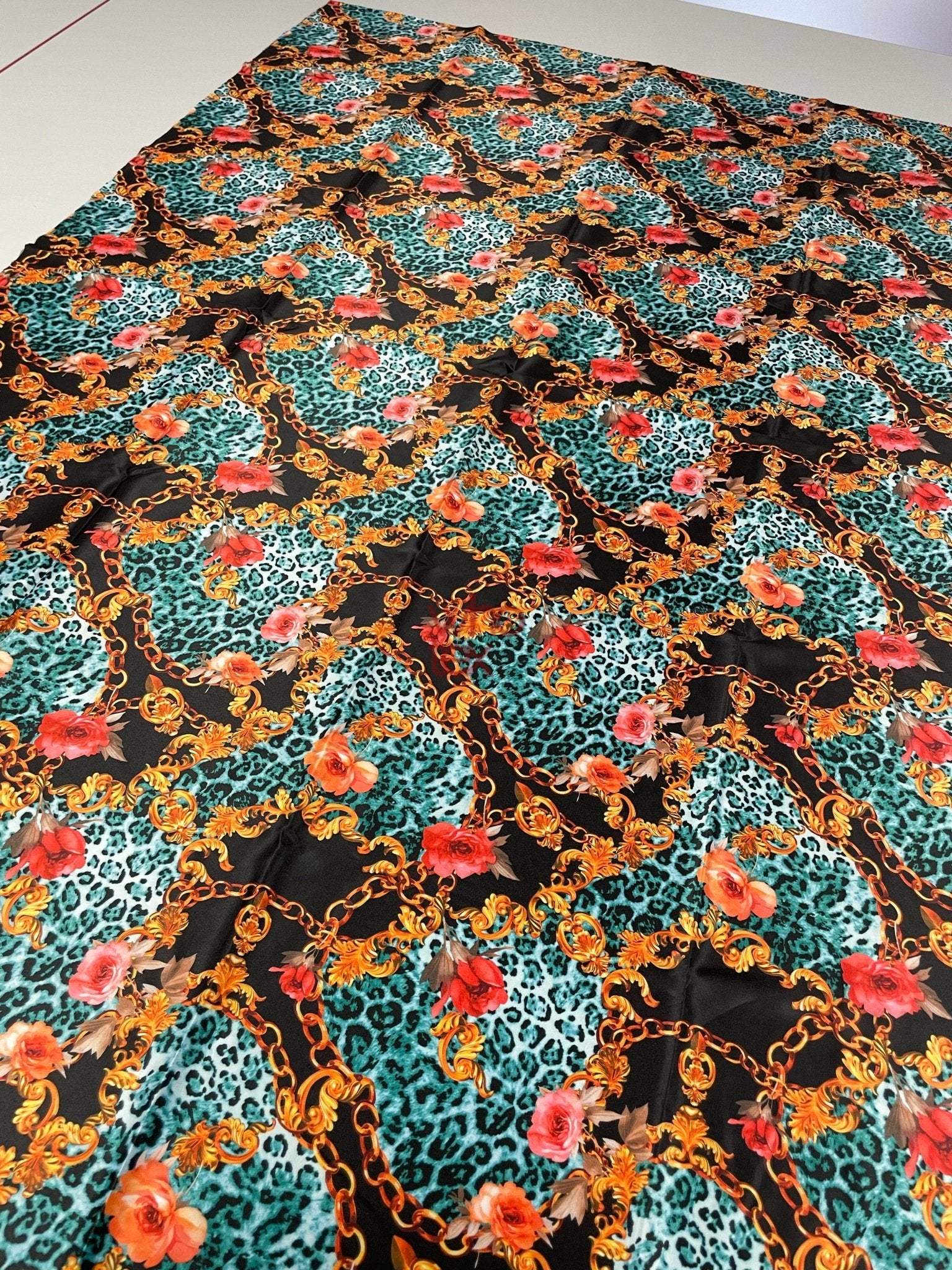 leopard print fabric with gold chains and floral accents in vibrant colors