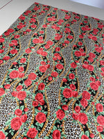 Leopard print fabric with red roses and gold chains pattern for sewing projects