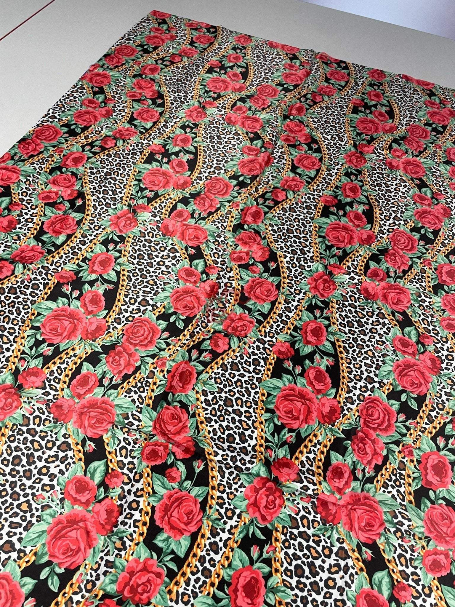 Leopard print fabric with red roses and gold chains pattern for sewing projects