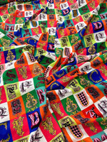 Colorful letter print cotton fabric with various alphabet designs on a checkered background, ideal for sewing and crafting projects
