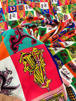 Colorful letter print cotton fabric with ornate alphabet designs on a soft, durable material