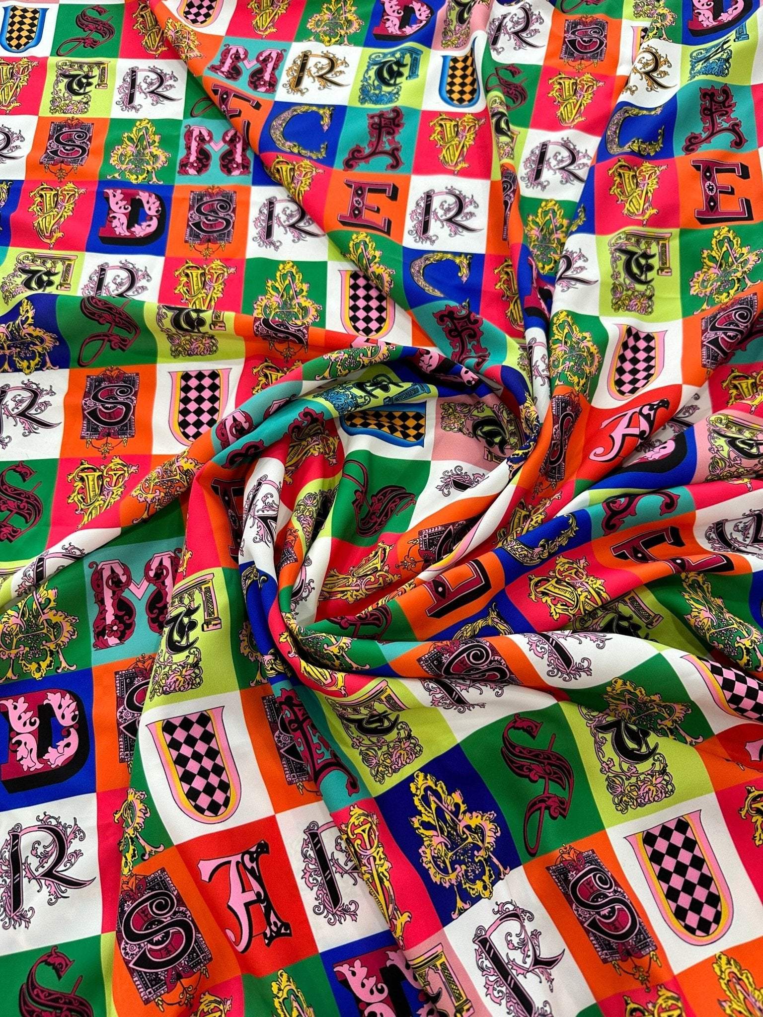 Colorful letter print cotton fabric with decorative alphabet blocks and a soft, durable texture perfect for sewing and crafting projects