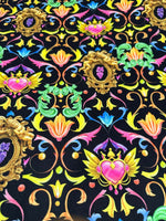 Vibrant black fabric with colorful baroque floral and heart pattern design