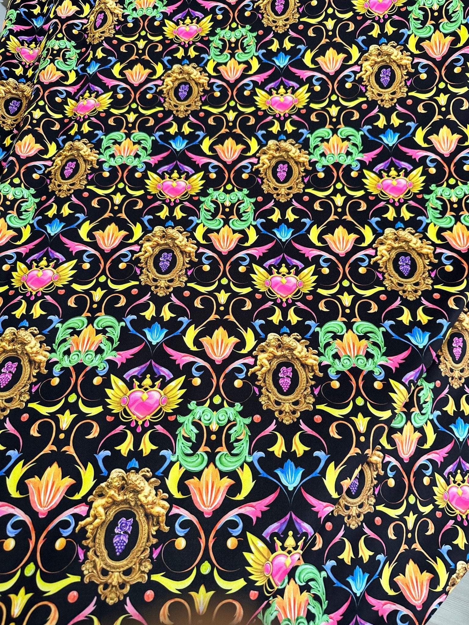 Vibrant black fabric with colorful baroque floral heart pattern and ornate gold frames