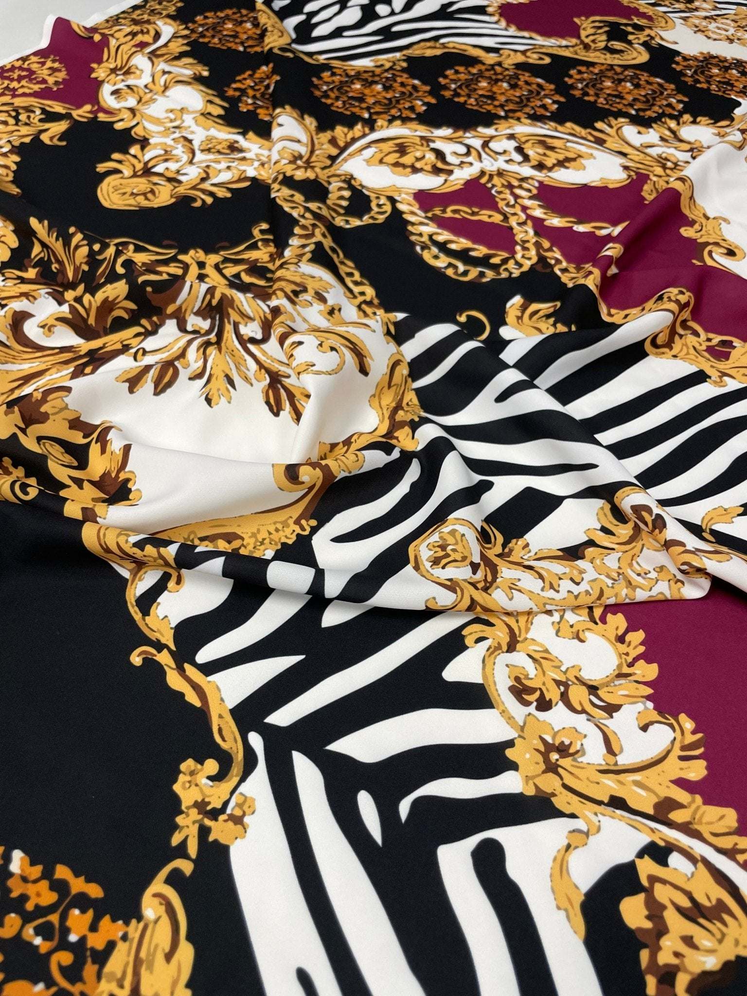 Luxury Baroque Zebra Chain Fabric with burgundy, gold Baroque patterns and zebra stripes on soft material