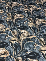 Dark blue and beige marble print satin fabric with smooth texture and elegant drape