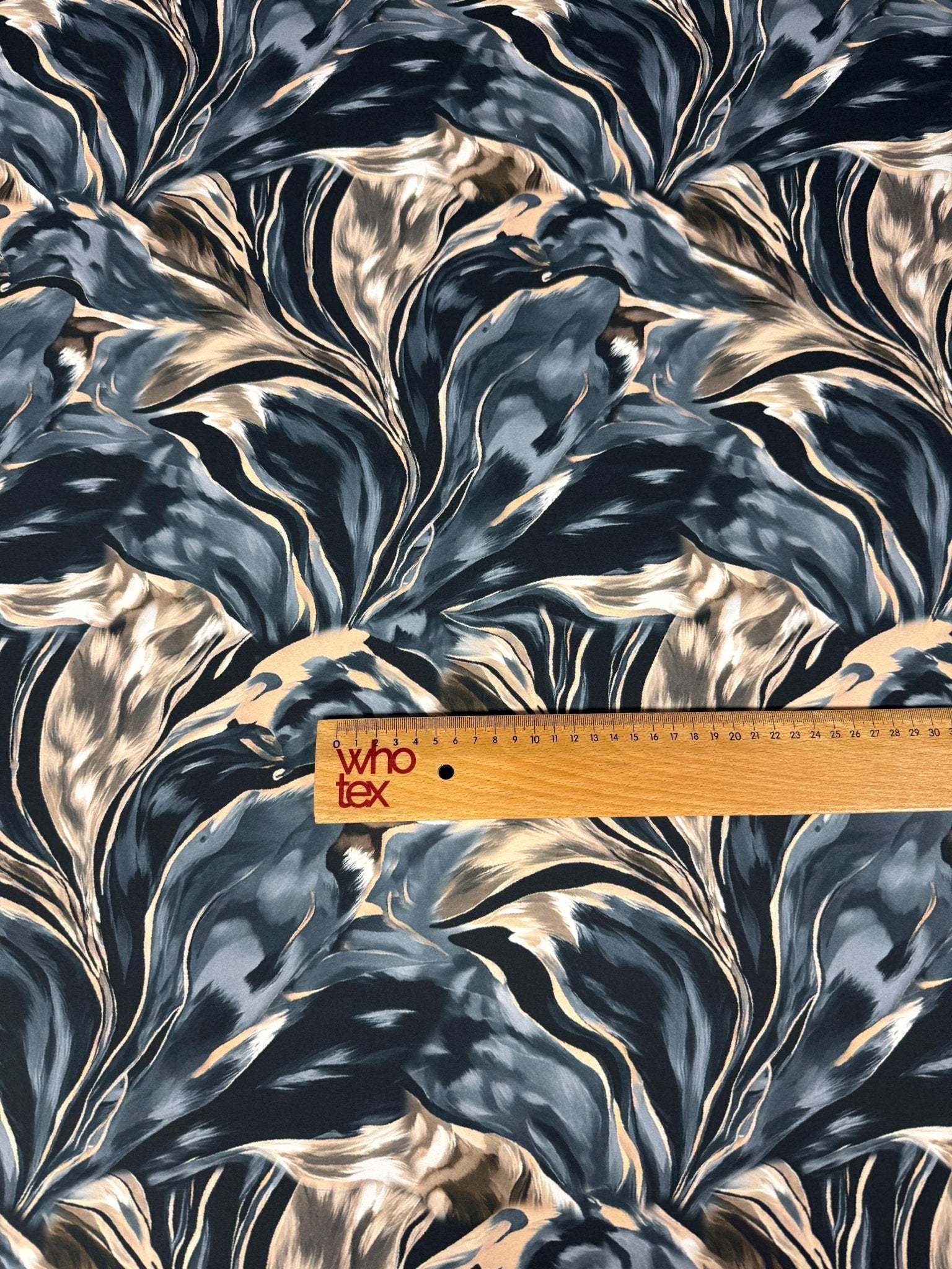 Dark blue and marble print satin fabric with smooth texture and elegant drape, suitable for garments and sewing projects