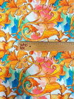 Luxury ornate medallion and chain print fabric with vibrant orange and blue design and ruler for scale