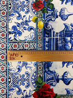 Majolica mosaic pattern Italian tile fabric with blue floral and ornamental designs and red rose accents.