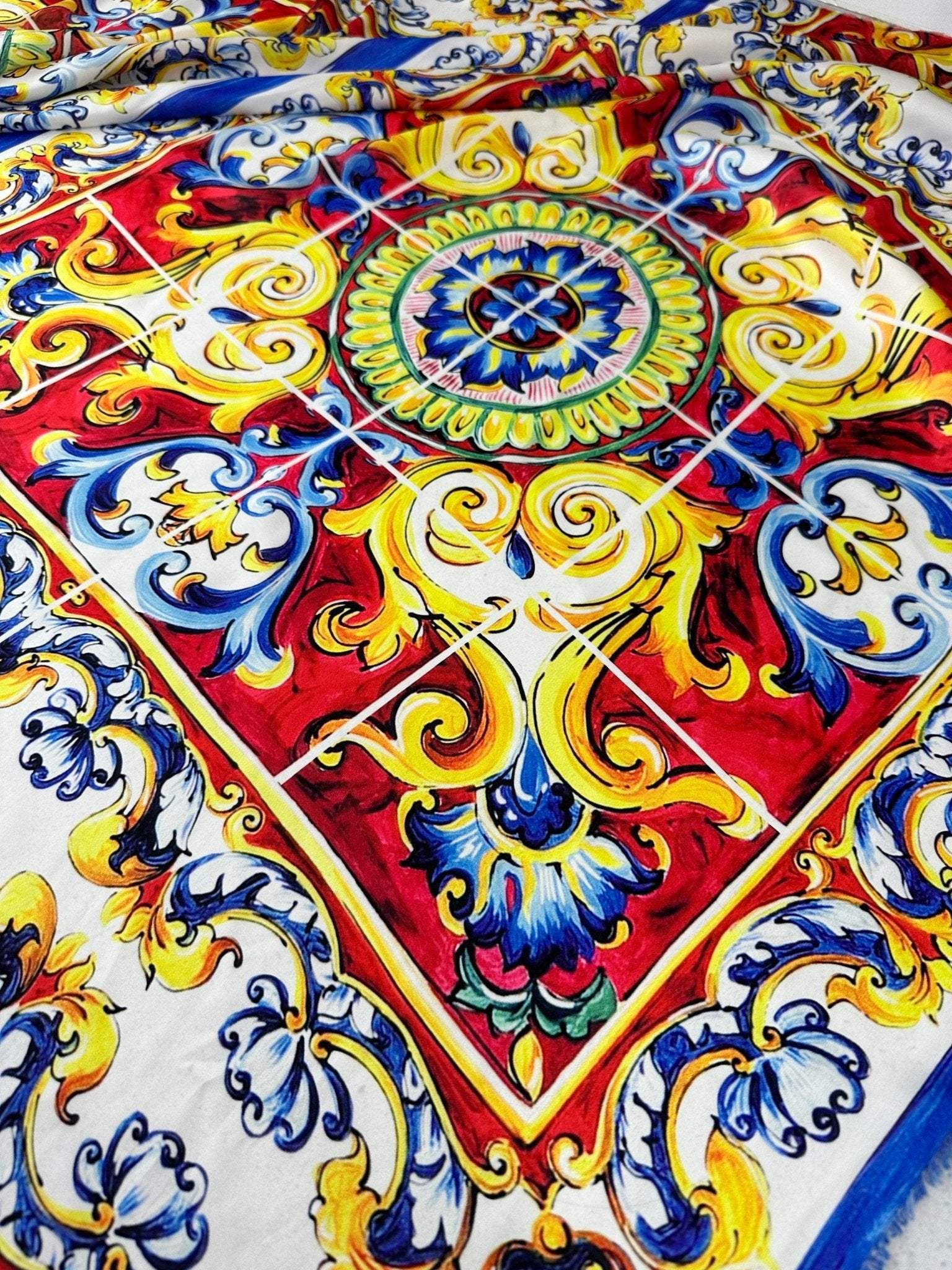 Majolica pattern luxury fabric with vibrant red, yellow, blue, and white ornate design suitable for upholstery or drapery