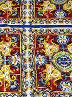 Majolica pattern luxury fabric with vibrant blue, red, yellow, and white ornate design for upholstery and fashion projects
