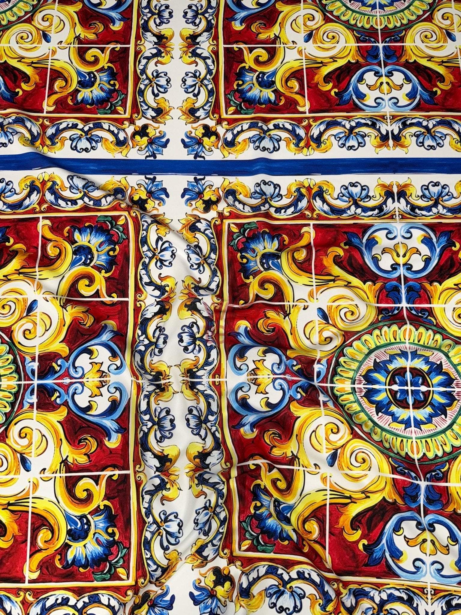 Majolica pattern luxury fabric with vibrant blue, red, yellow, and white ornate design for upholstery and fashion projects