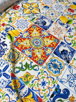 Colorful Majolica pattern fabric with intricate tile designs and bright floral accents for sewing crafts