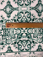 Green and white Majolica pattern fabric with intricate swirl design and ruler for scale