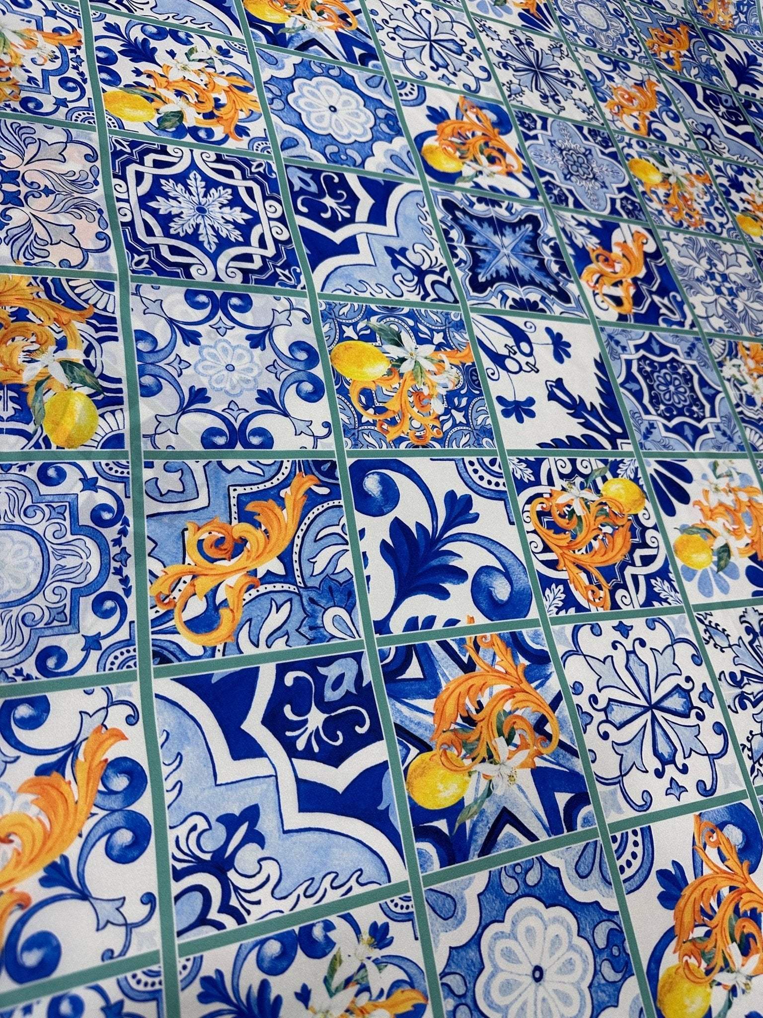 Majolica Lemons Luxury Fabric with vibrant blue and orange lemon-inspired tile pattern, ideal for upholstery and drapery.