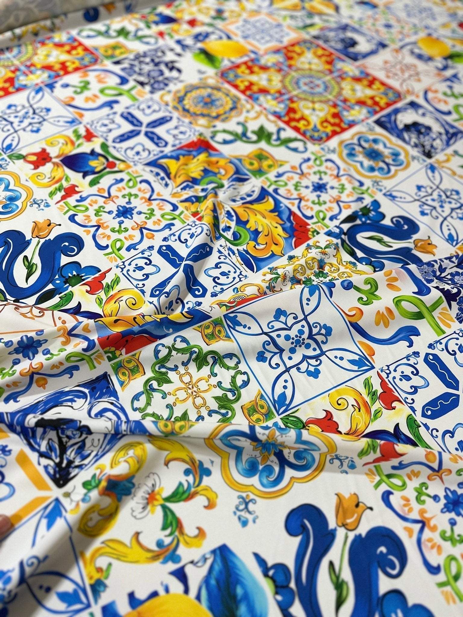 Luxury Majolica pattern fabric with vibrant blue, yellow, and green tile-inspired designs, ideal for upholstery and drapery.