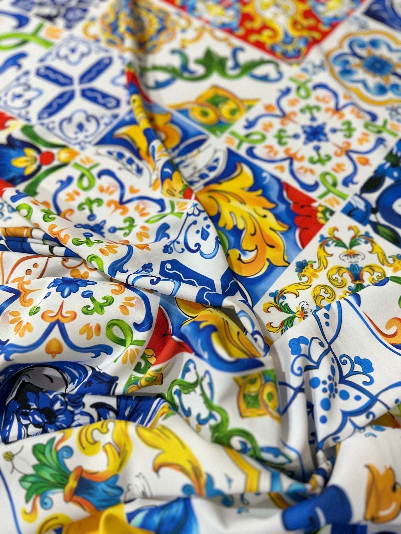 Luxury Majolica pattern fabric with vibrant blue, yellow, green, and red ornamental tiles, ideal for upholstery and drapery.