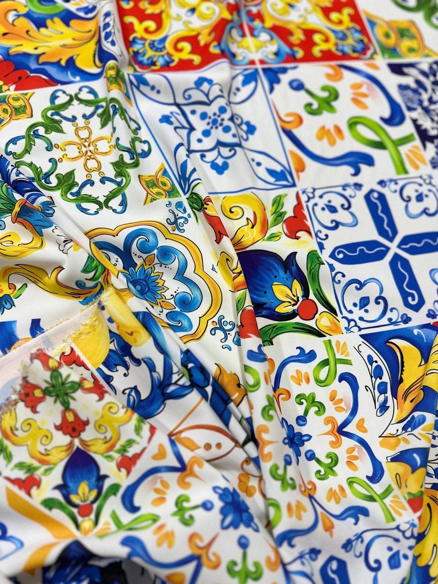 Luxury Majolica pattern fabric with vibrant blue, yellow, red, and green tile-inspired designs, perfect for upholstery and drapery.