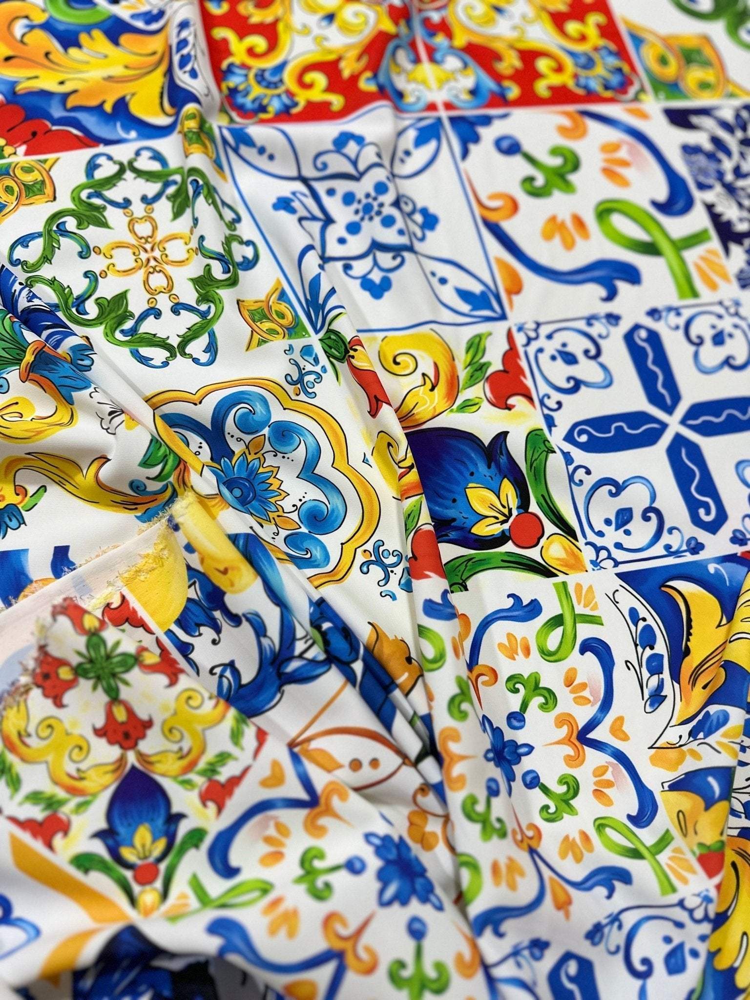 Luxury Majolica pattern fabric with vibrant blue, yellow, red, and green tile-inspired designs, perfect for upholstery and drapery.