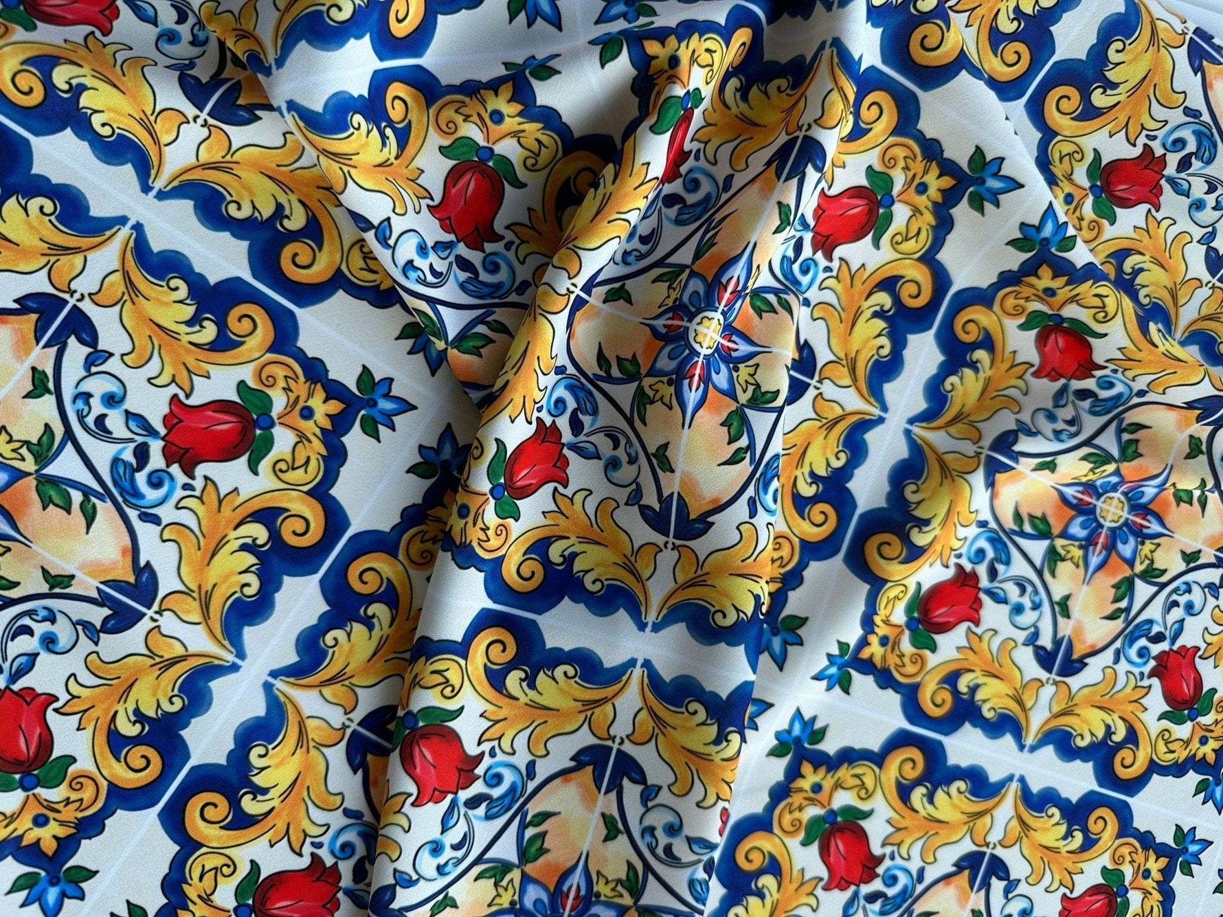 Colorful Majolica pattern fabric with traditional Sicilian floral and ornamental designs in blue, yellow, red, and green.