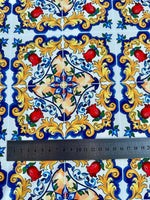 Close-up of Majolica Pattern Fabric with vibrant Sicilian-inspired floral and geometric design featuring red flowers and yellow ornate details next to a ruler for scale