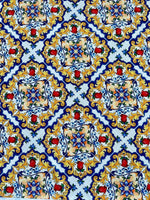 Majolica pattern fabric with vibrant Sicilian-inspired floral and geometric designs in blue, yellow, and red on white background