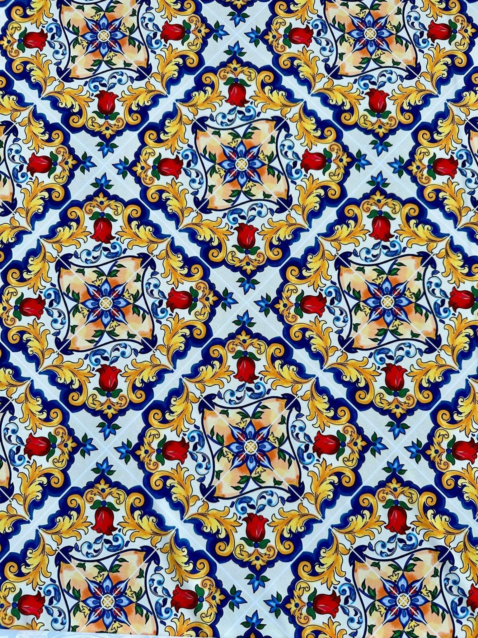 Majolica pattern fabric with vibrant Sicilian-inspired floral and geometric designs in blue, yellow, and red on white background