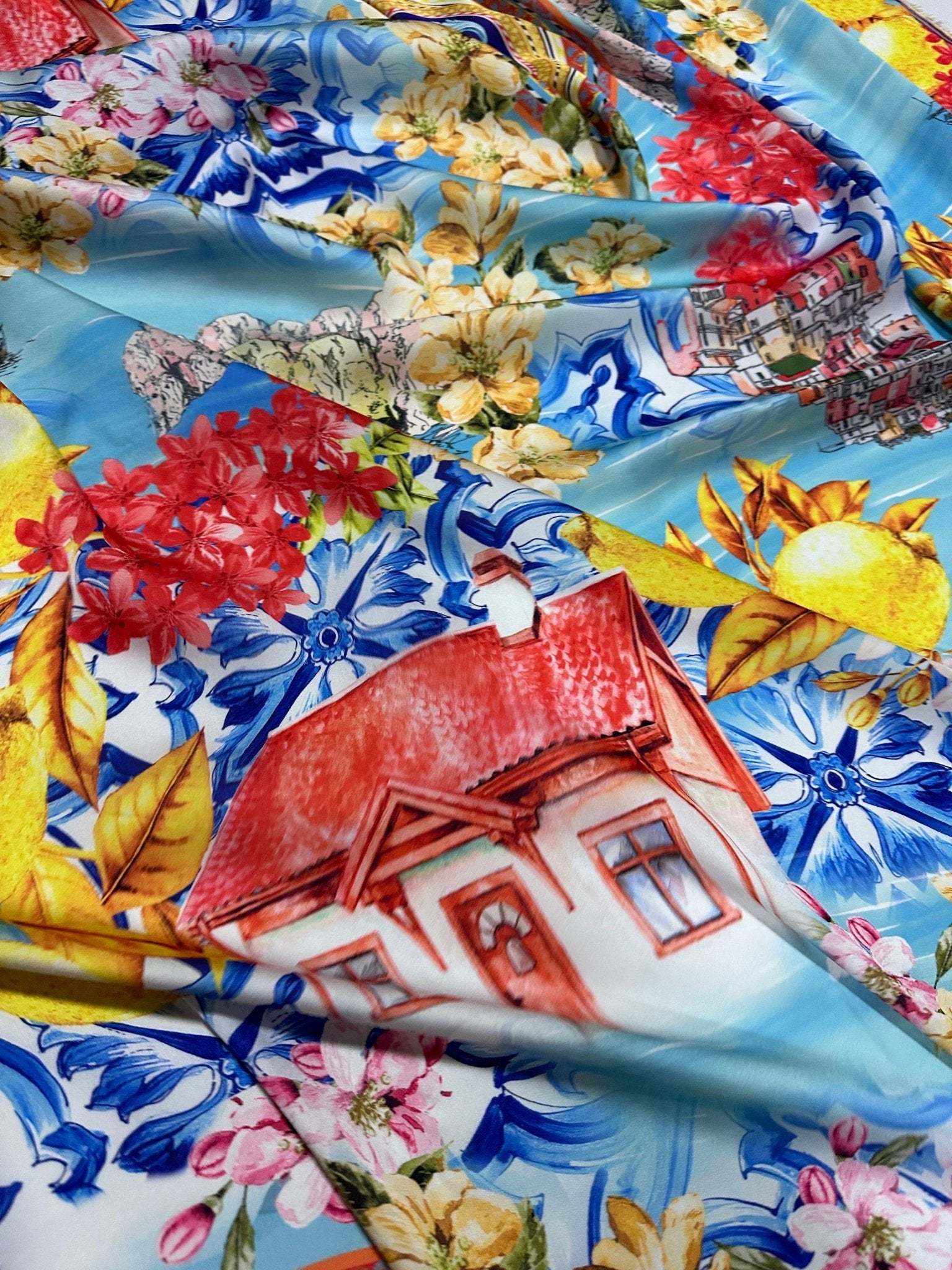 Bright Majolica Sicilian print fabric with vibrant floral and architectural patterns on blue background